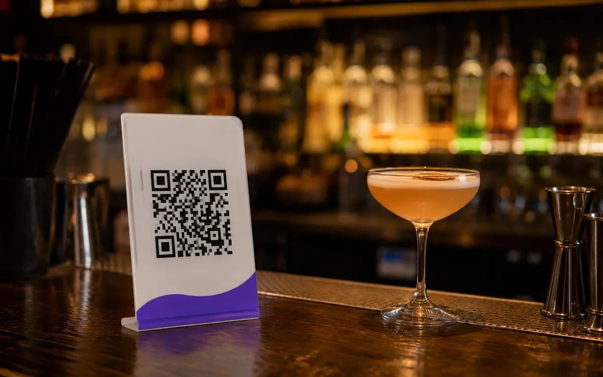 Bar counter with a small stand holding a QR code for the drinks list